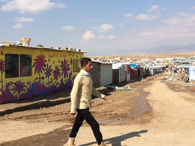 A man walks past a mural painted in a project run by AptART and ACTED in Domiz refugee camp, Dohuk, Kurdistan Region of Iraq. The project, bringing together street artists and refugee children, was funded by the European Commission's Humanitarian Aid and Civil Protection department, ECHO and UNICEF. Photo: EU/ECHO/Caroline Gluck
